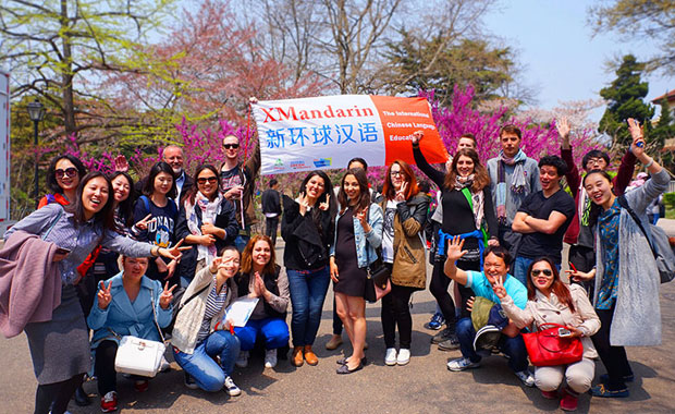 22 people group photo during an outdoor fun event; Chinese language students and teachers enjoy time outside of class too